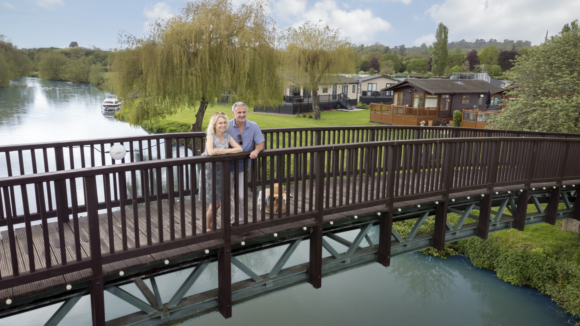 couple standing on bridge over river