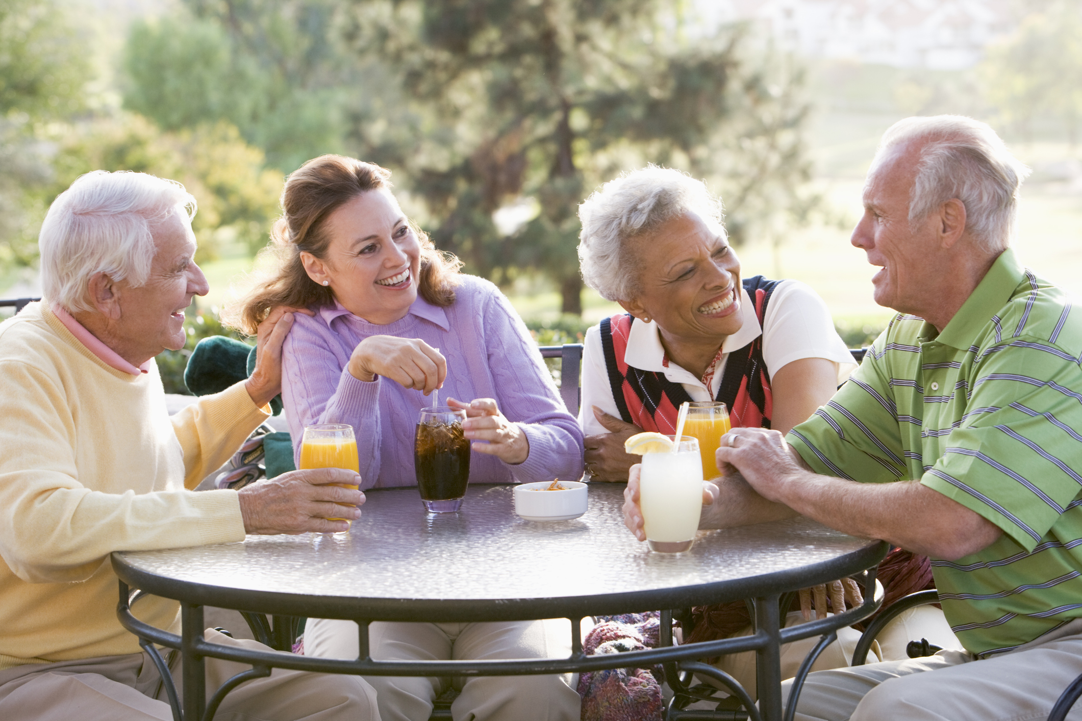 Friends Enjoying Beverage By A Golf Course